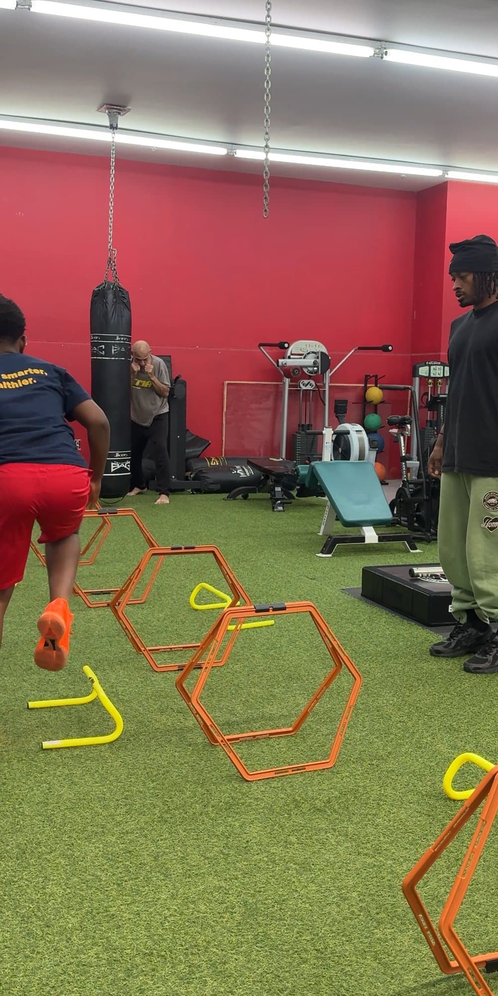 Zu coaching a young athlete through an agility drill