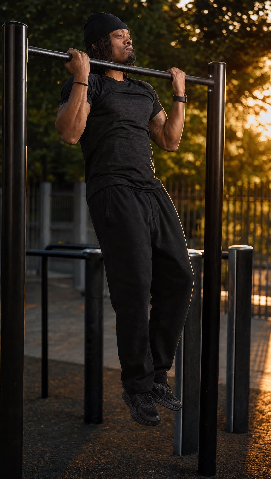 Zu hanging from a pull-up bar at sunset